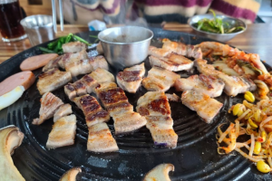 A traveller enjoying Jeju's famous local specialty, grilled black pork. Photo with permission from a blogger