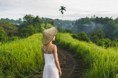 A young traveler exploring rice fields and nature in Bali