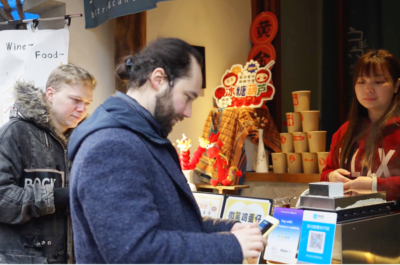 International visitors using mobile payment at a food merchant in China